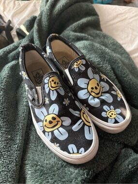 Vans Black Slip-On Sneakers with Blue & Yellow Smiley Daisy Print